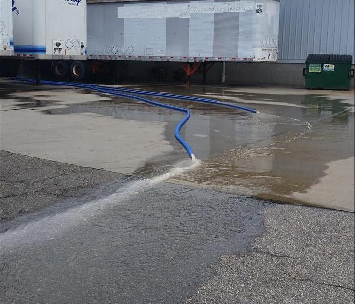 Water is being pumped out of this warehouse after a flood. 