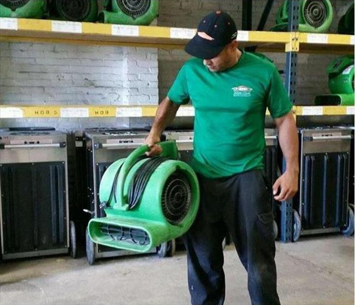 Our tech, Jose, holding a SERVPRO air mover.