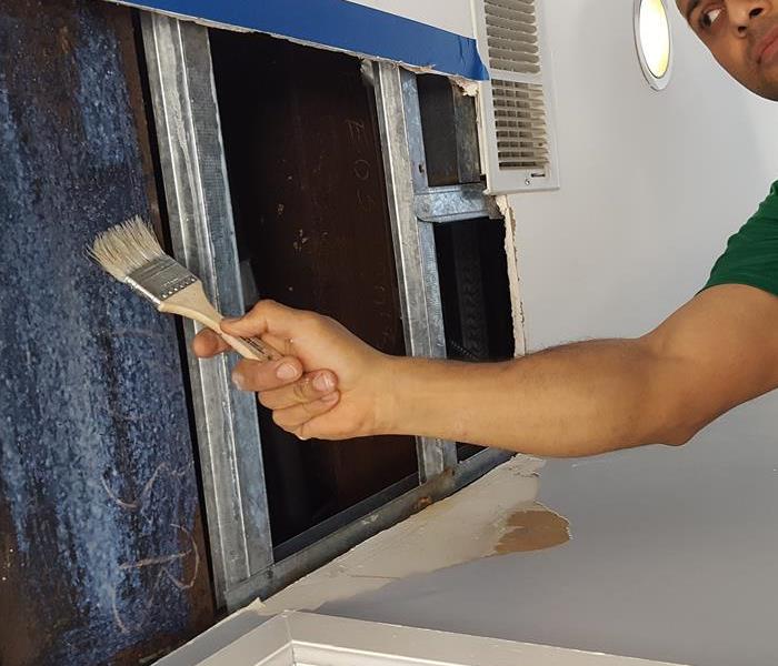 Our technician applying SERVPRO products to properly rid of the mold.